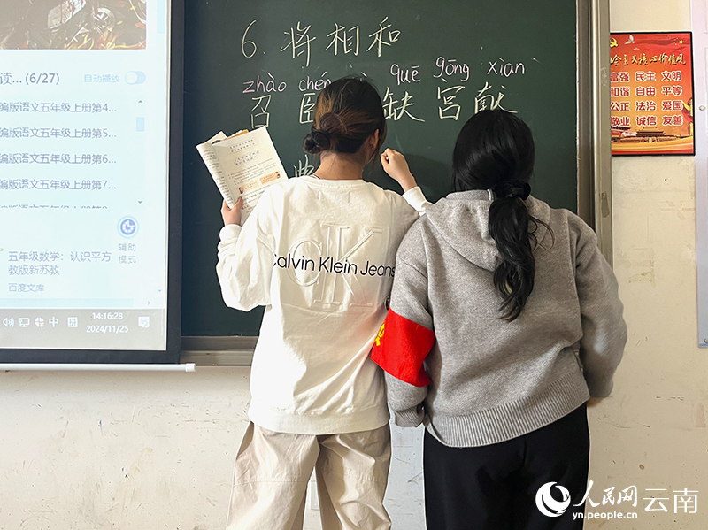 2影子老师(右)陪同学生一同上台回答问题。人民网-尹馨摄